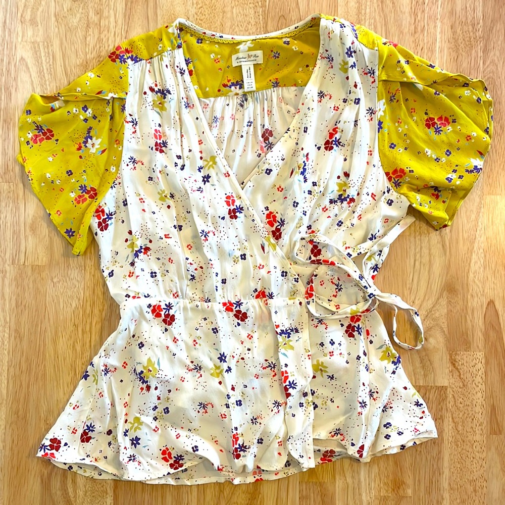 Anthropologie wrap top. Yellow and white with pink and blue flowers . Size 6.